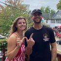 Bridget and Charlie Berens make a W sign with their thumbs and forefingers.